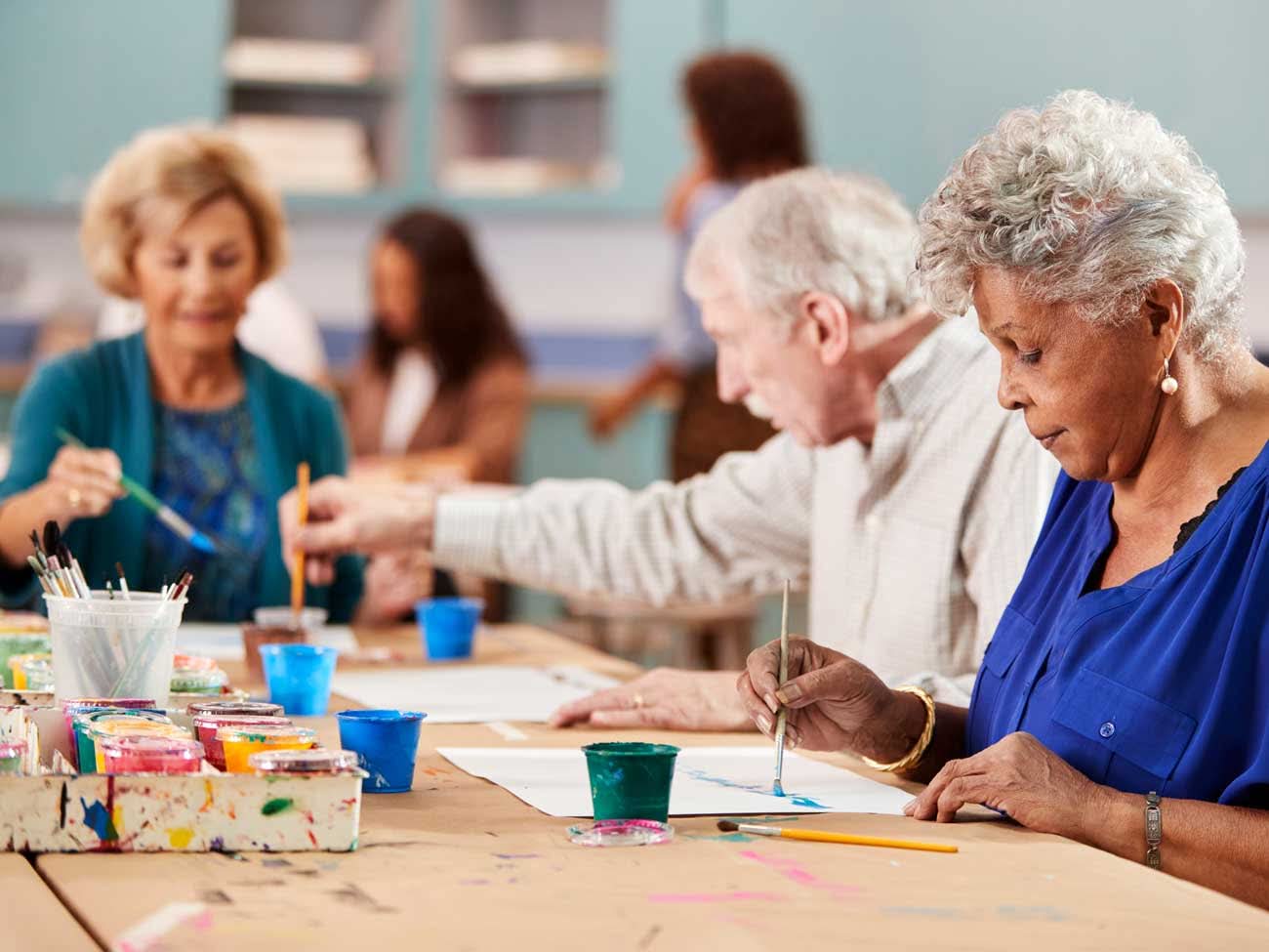 Older adults painting together at an art class